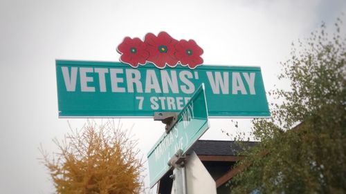 Low angle view of road sign against sky