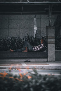 Man sleeping on street in city