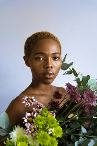 Portrait of a young woman with red flower