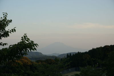 Scenic view of mountains against sky at sunset