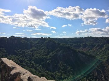 Scenic view of landscape against cloudy sky