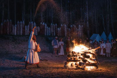 Group of people in traditional clothing at night