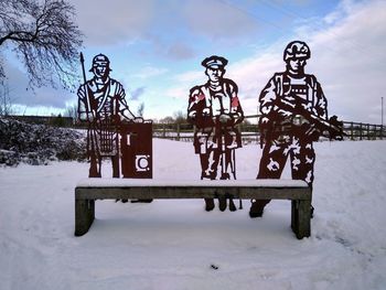 Built structure on snow covered field against sky