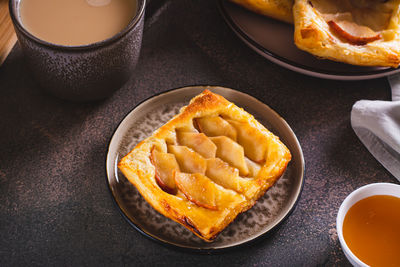 Small upside down puff pastry cake with apple on a plate