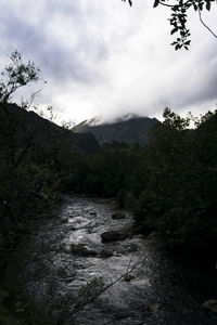 Scenic view of waterfall against sky