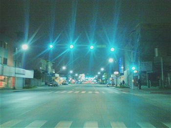 Illuminated city street at night