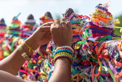 Severed hand of a person holding souvenir ribbons