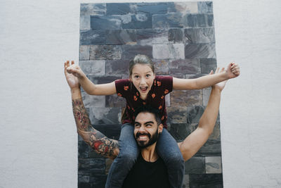 Portrait of a smiling young woman with arms outstretched