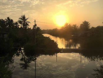 Scenic view of lake against sky during sunset
