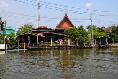 Building by river against sky