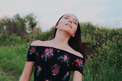 Midsection of beautiful woman on field