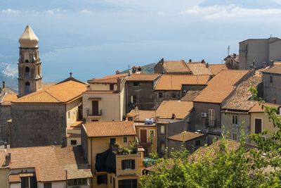 Buildings in town against sky