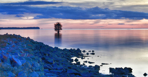 Scenic view of sea against cloudy sky