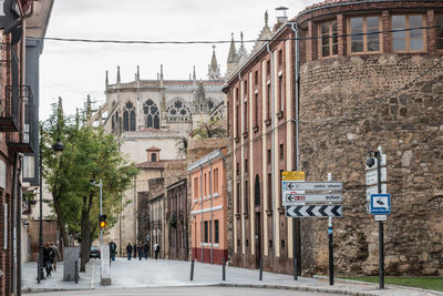 Road sign on street amidst buildings in city