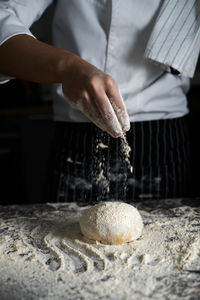 Midsection of man preparing food