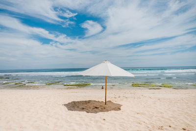 Scenic view of a beach with white sand in uluwatu, indonesia