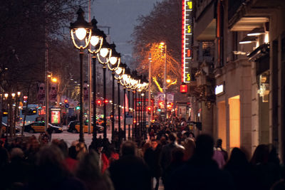 People on illuminated street lights at night