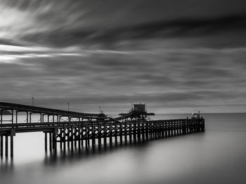 Pier in sea at dusk