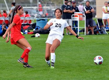 Group of people playing soccer on field