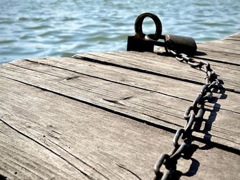 High angle view of chain on pier over lake