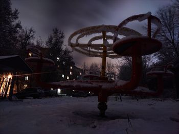 Ferris wheel against sky during winter at night