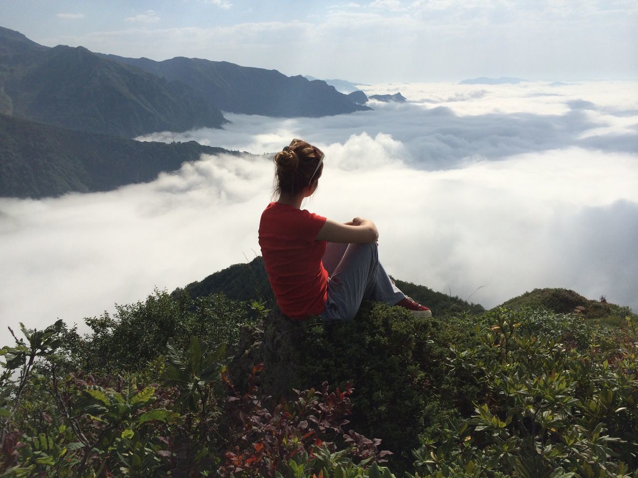 lifestyles, leisure activity, mountain, sky, full length, casual clothing, beauty in nature, landscape, rear view, cloud - sky, tranquil scene, tranquility, nature, scenics, getting away from it all, sitting, hiking, standing