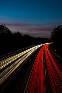 High angle view of light trails on road at night