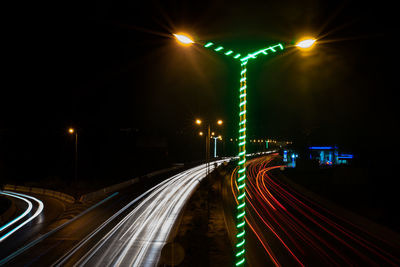 High angle view of light trails on road at night