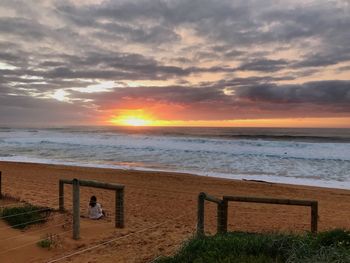 Scenic view of beach against sky during sunset