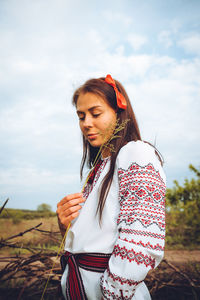 Photo of a smiling young woman in ethnic ukrainian shirt