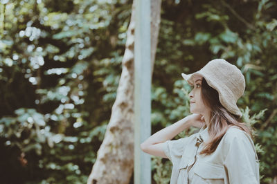 Young woman surrounded by nature look at faraway , freedom , hope and dream concept