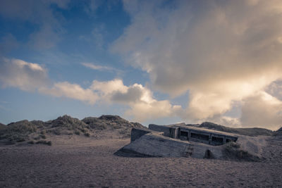 Scenic view of sand dunes against sky