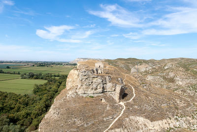 Scenic view of landscape against cloudy sky