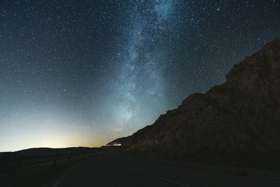 Scenic view of road against sky at night