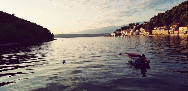 People on lake against sky