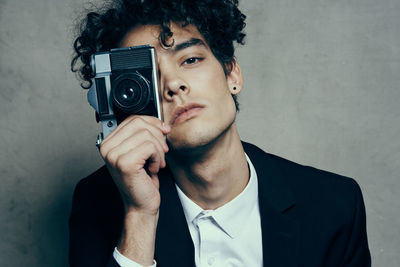 Portrait of young man photographing
