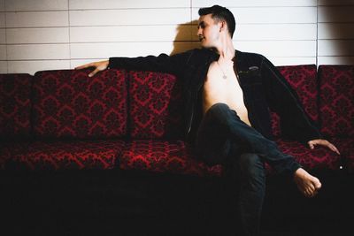 Young man sitting on sofa