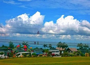 Power lines against cloudy sky