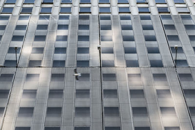 Low angle view of bird flying against building