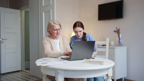 Young woman using laptop at home