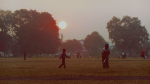 People on grassy field