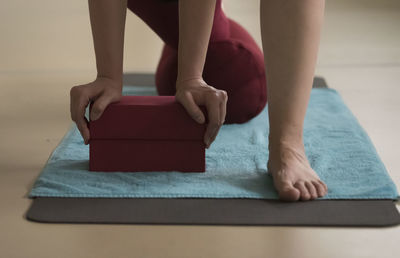 Low section of woman sitting at home