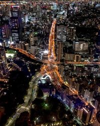 High angle view of city lit up at night