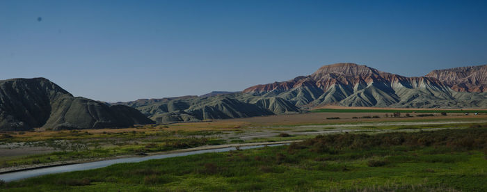 Scenic view of mountains against clear blue sky