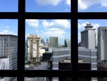 Modern buildings against cloudy sky