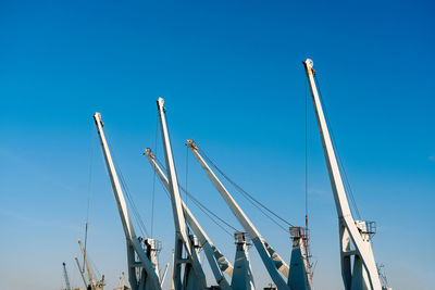 Low angle view of sailboats against clear blue sky