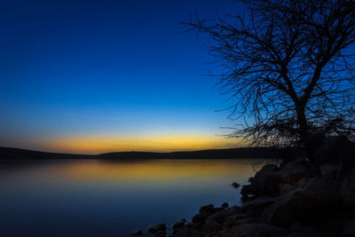 Scenic view of sea against clear sky at sunset