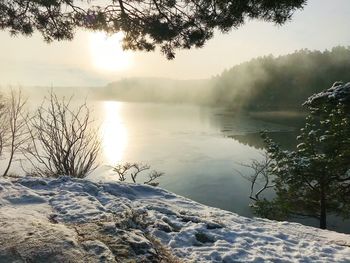 Scenic view of lake against sky during winter