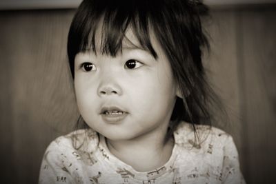 Close-up of cute girl looking away