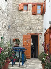 Potted plants on footpath against building